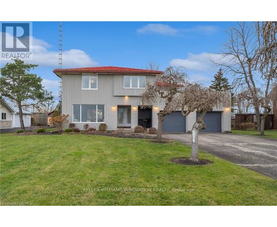 A house with a red roof and a tree in front of it.