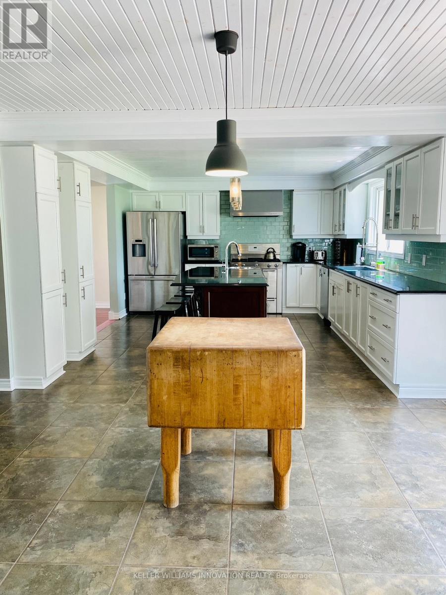 A kitchen with a wooden box on the floor.