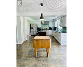 A kitchen with a wooden box on the floor.