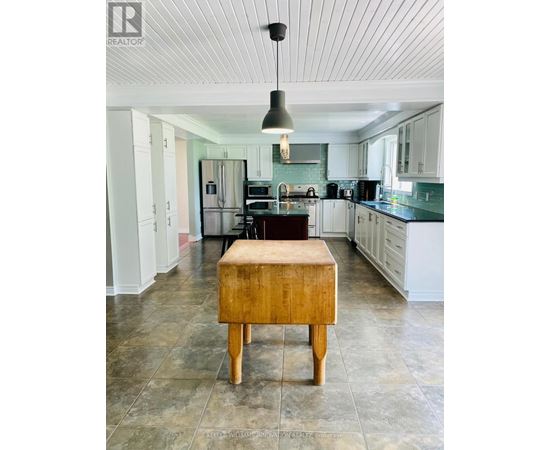 A kitchen with a wooden box on the floor.