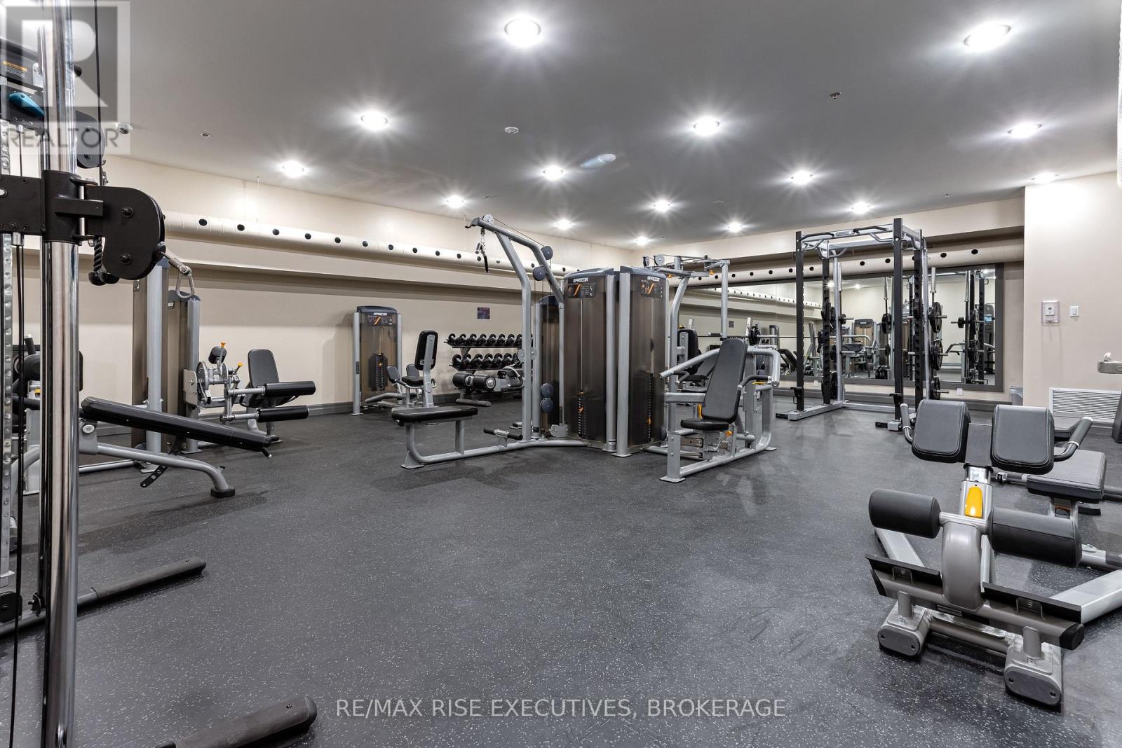 A gym with a variety of equipment including a squat rack, bench press, and leg press.