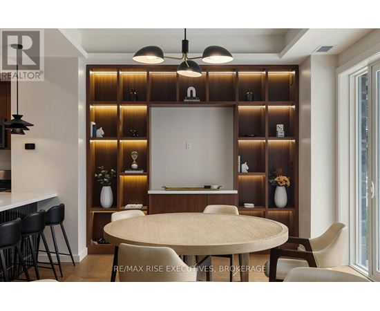 A modern dining room with a round table and chairs.