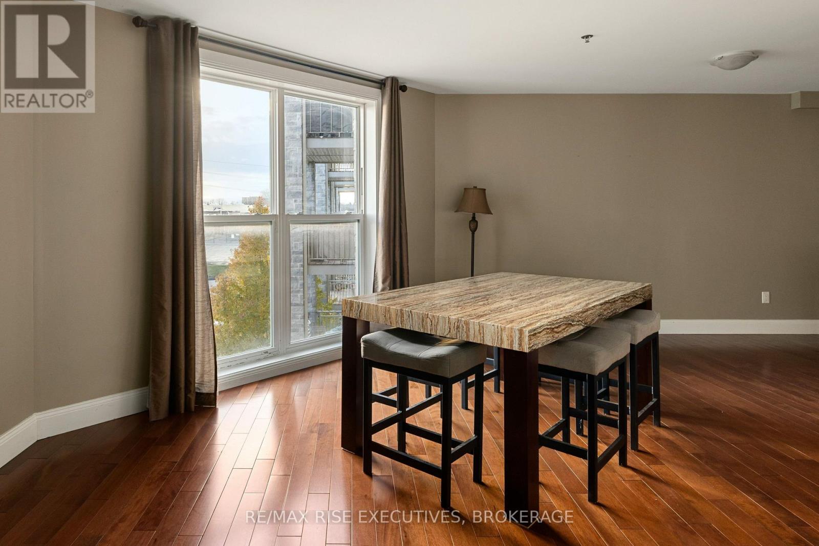 A dining room with a wooden table and chairs.