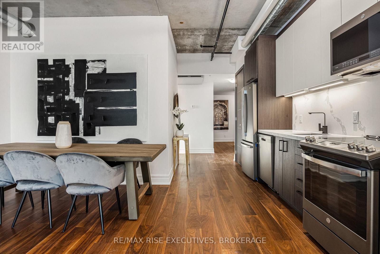 A modern kitchen with a dining table and chairs.