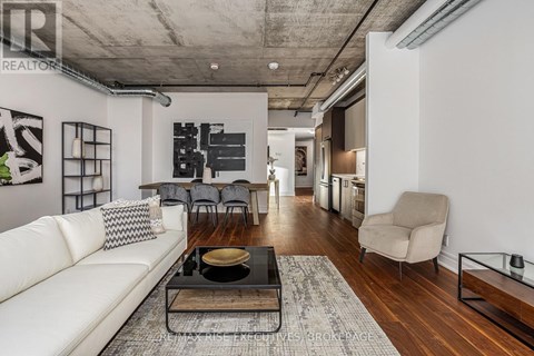 A modern living room with a white sofa and a coffee table.