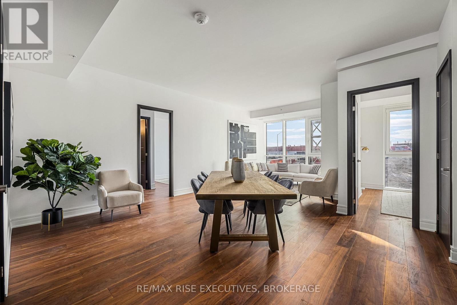 A well-lit, spacious room with a dining table and chairs.