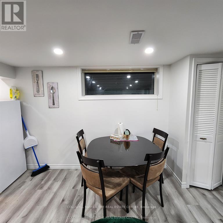 A dining room with a table and chairs.