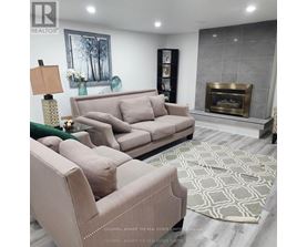 A living room with a fireplace and a couch.