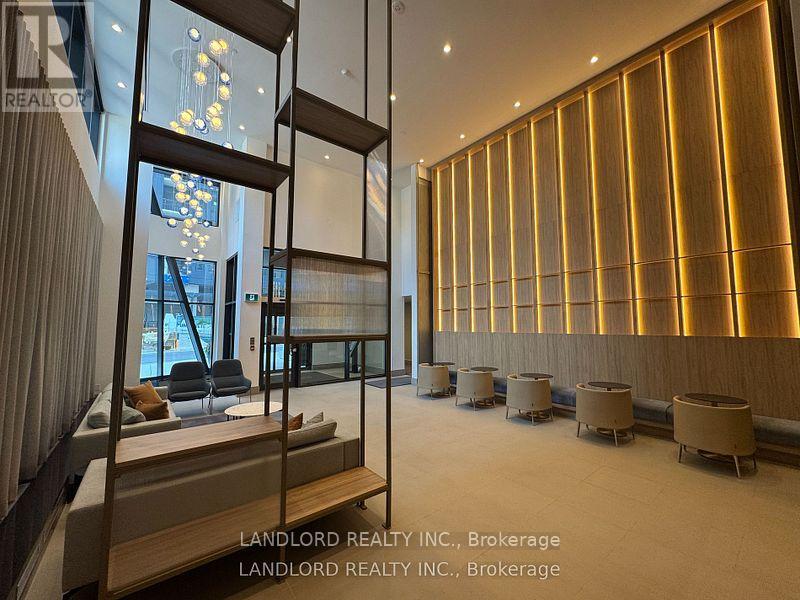 A spacious room with wooden walls and a glass partition.