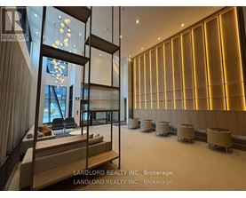 A spacious room with wooden walls and a glass partition.