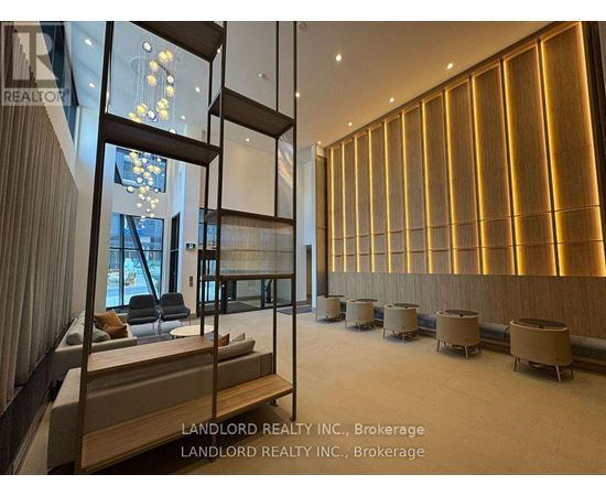 A spacious room with wooden walls and a glass partition.