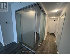 A glass door in a white room with a sign that says "REALTOR".