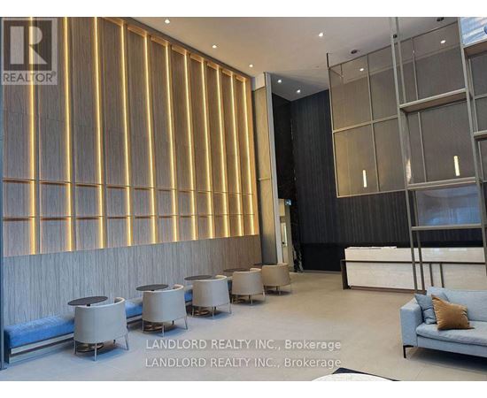 A modern living room with a blue sofa and a wooden wall panel.