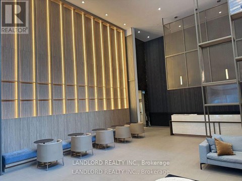 A modern living room with a blue sofa and a wooden wall panel.