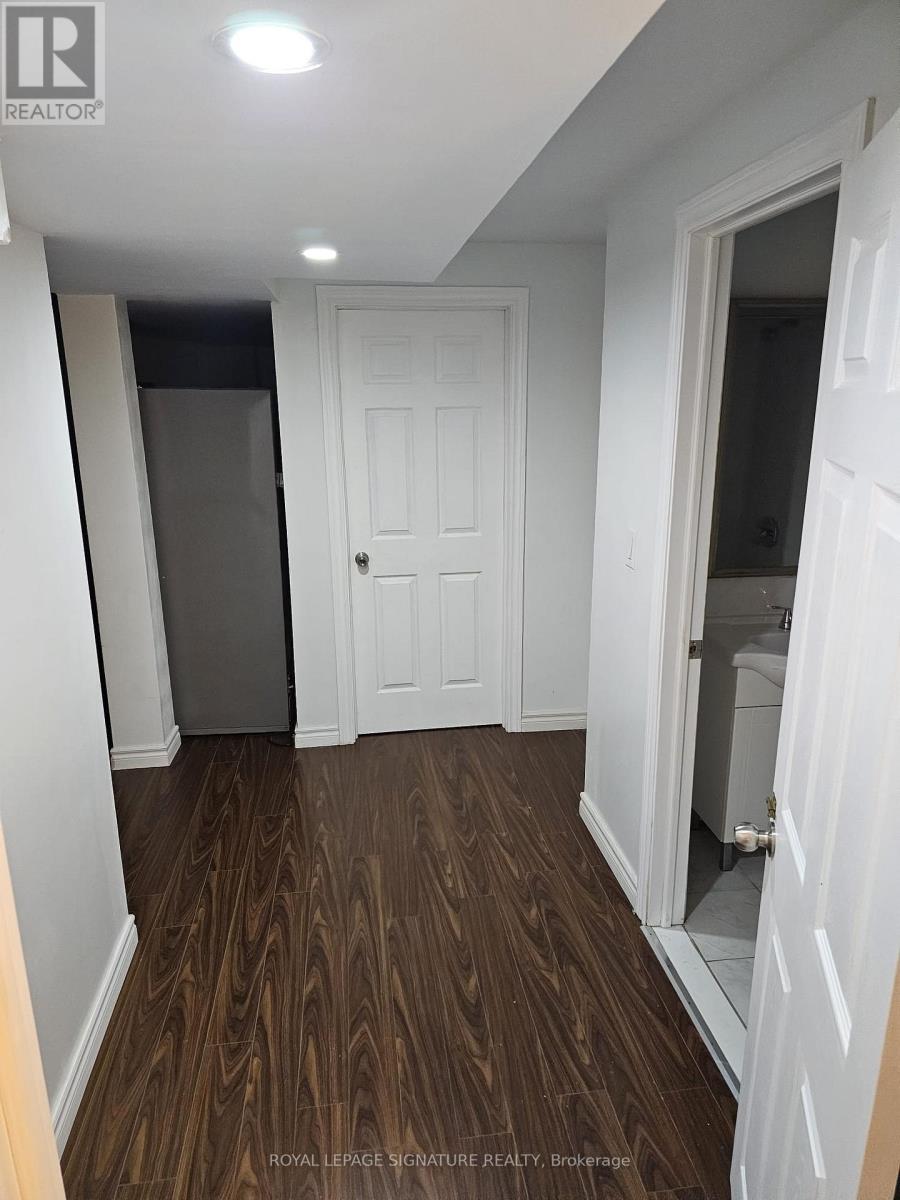 A hallway with a white door and a white wall.