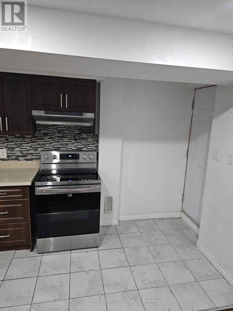A kitchen with a stove top oven and a microwave.