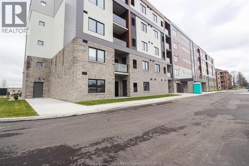 Apartment building with a green door on the right side.