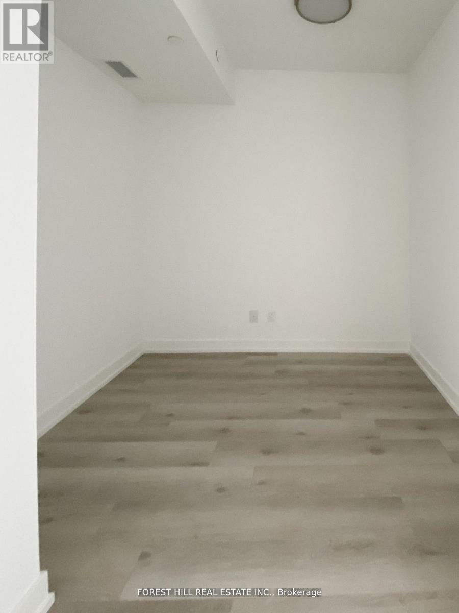 A room with a wood floor and white walls.