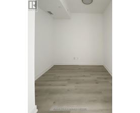 A room with a wood floor and white walls.