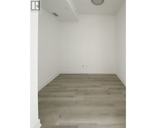 A room with a wood floor and white walls.
