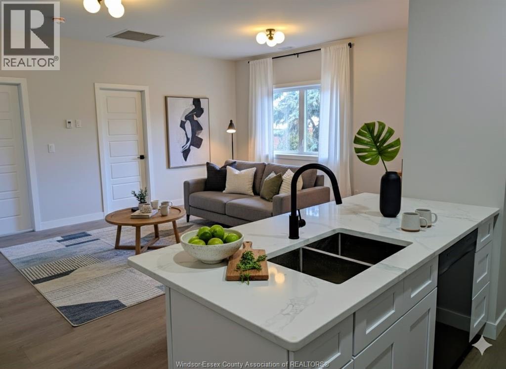 A modern kitchen with a white countertop and a large window.