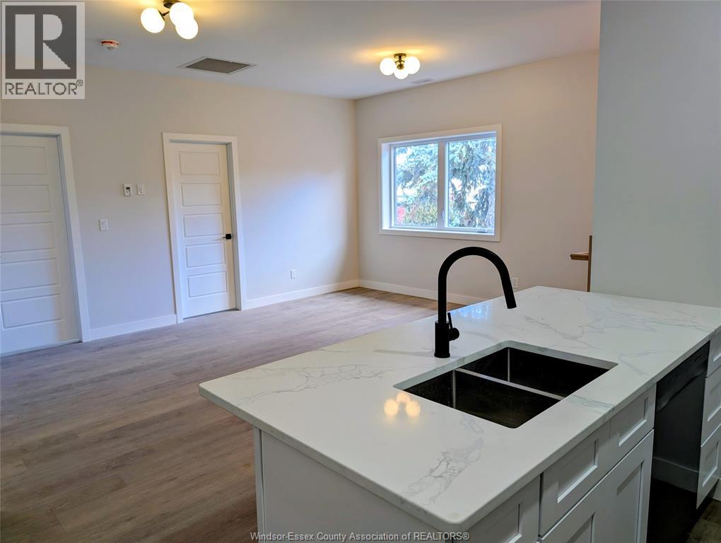 A kitchen with a sink and a window.