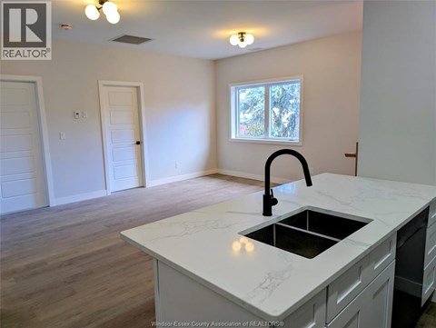 A kitchen with a sink and a window.
