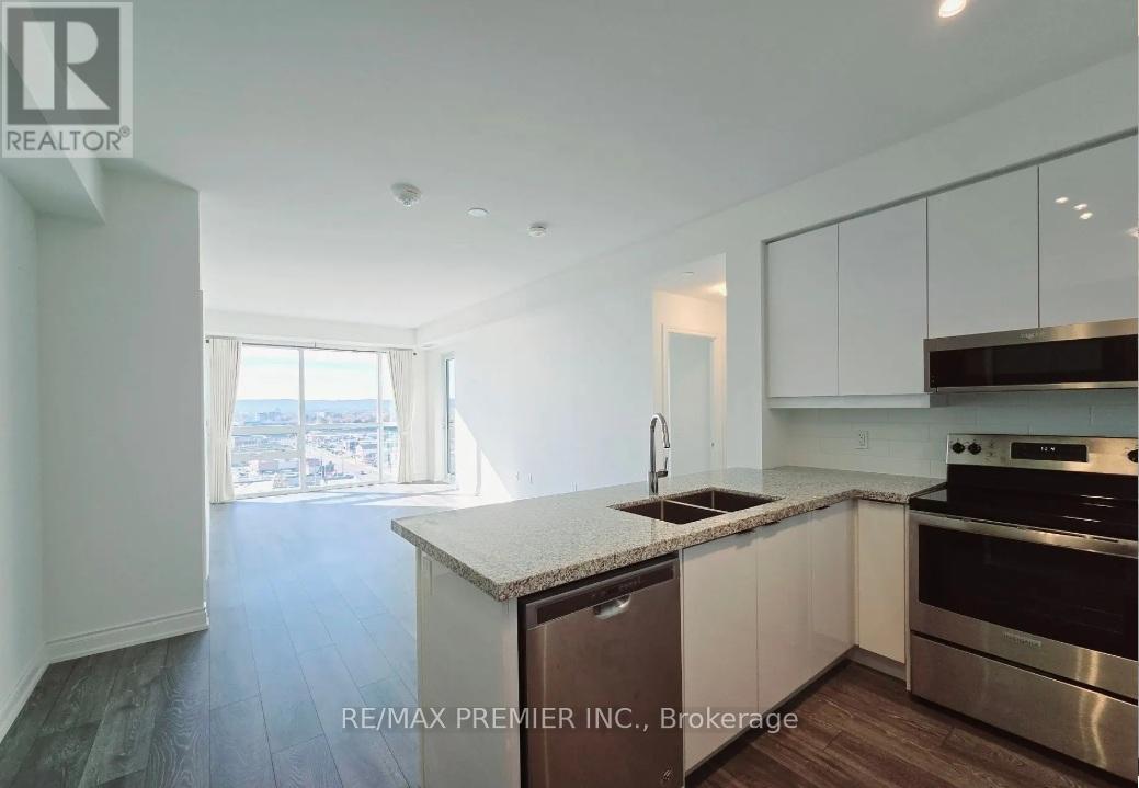 A kitchen with a stainless steel dishwasher and oven.