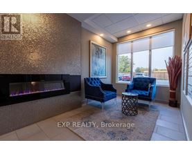 A living room with a fireplace and blue chairs.