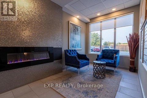 A living room with a fireplace and blue chairs.