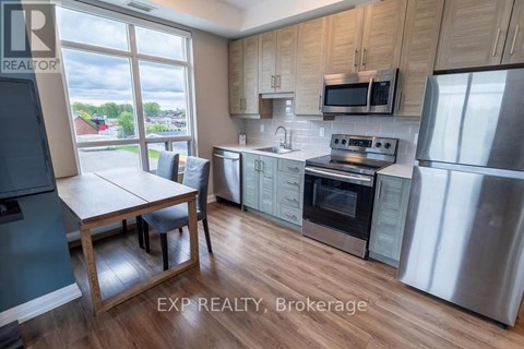 A kitchen with wooden cabinets and stainless steel appliances.