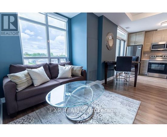 A living room with a grey couch and a glass coffee table.