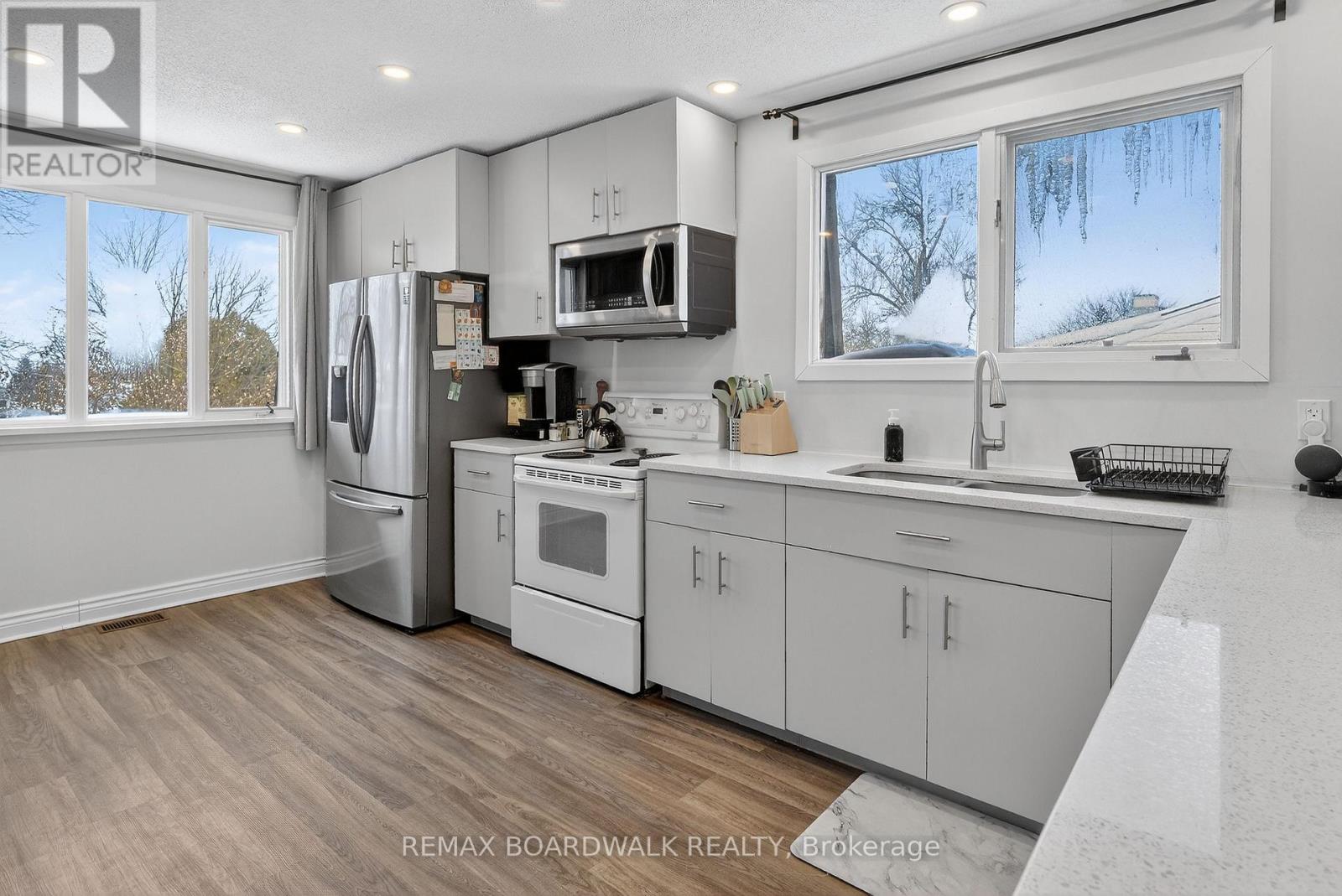 A kitchen with white cabinets and appliances is on the market.