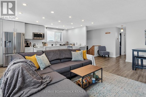 A modern living room with a grey couch and a coffee table.