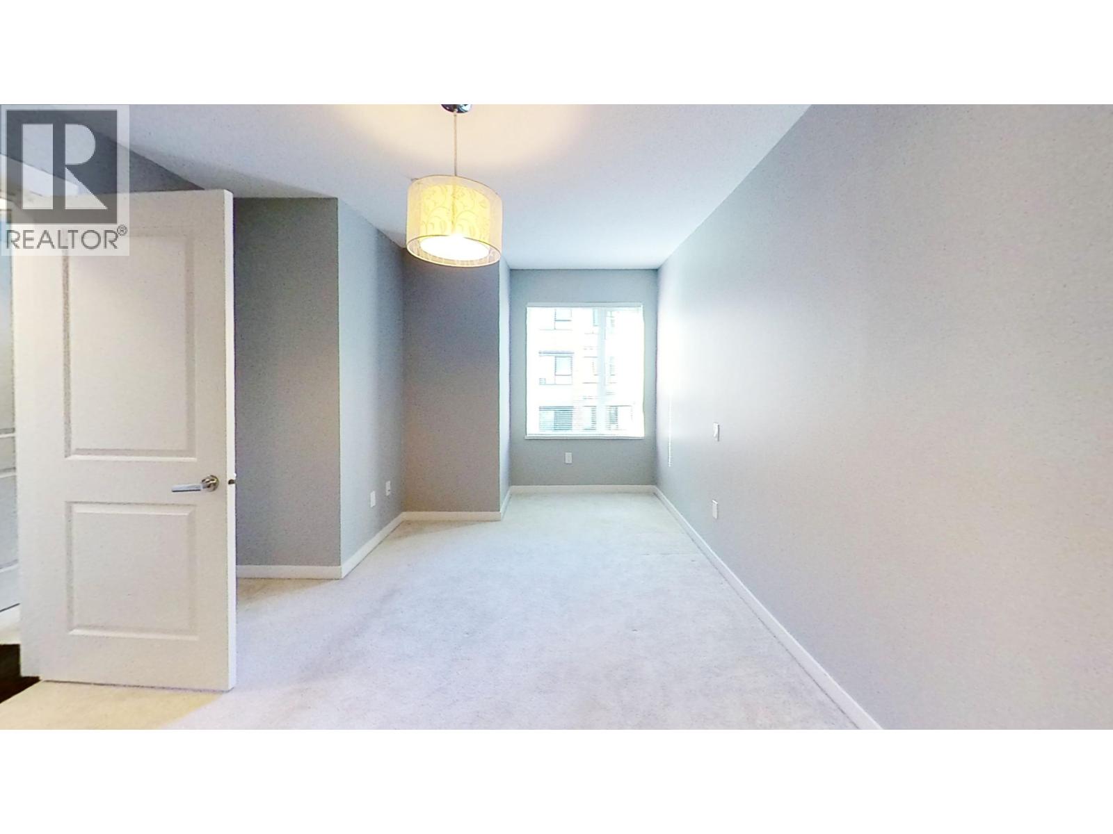 A realtor sign is on the door in a white room.