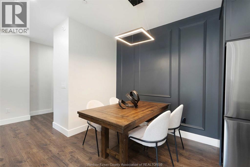 A kitchen with a wooden table and chairs.