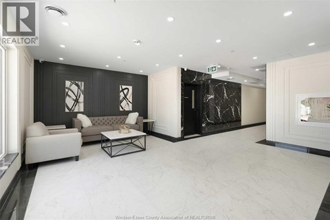 A spacious living room with a grey sofa and a coffee table.
