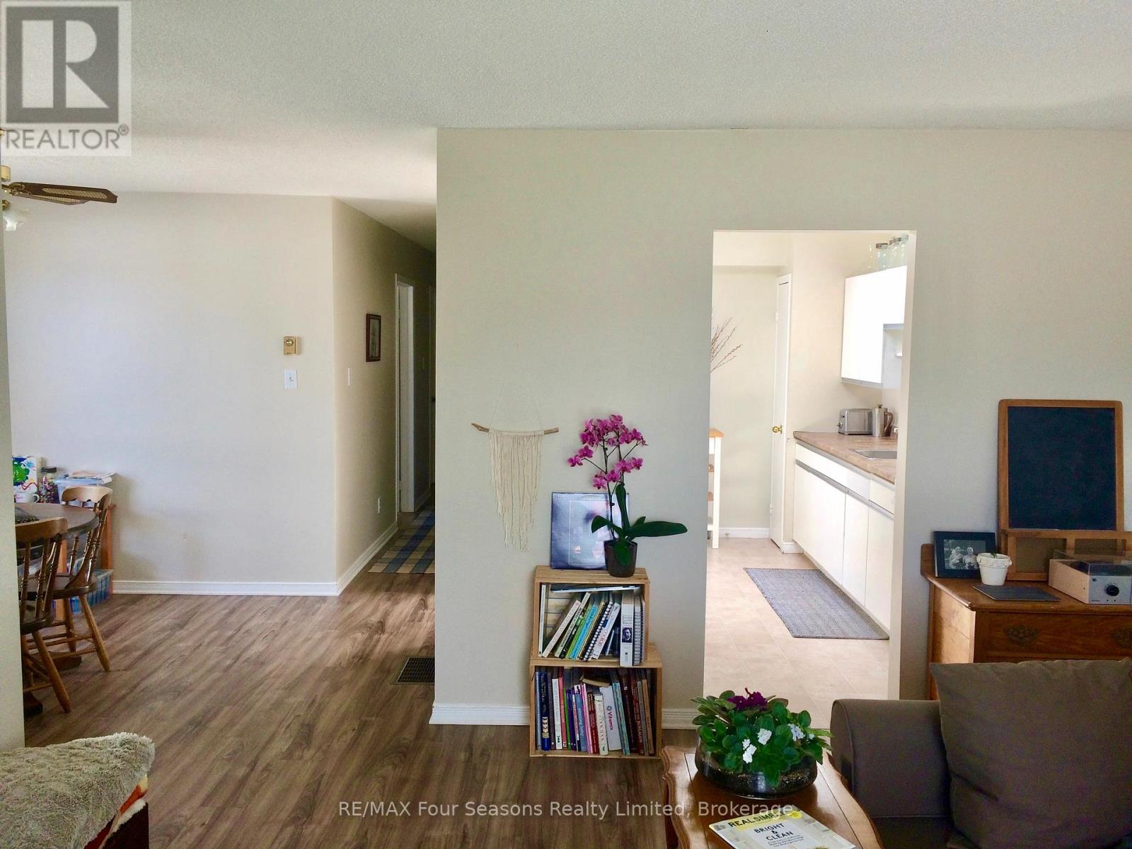 A living room with a couch, a coffee table, a bookshelf, and a window.