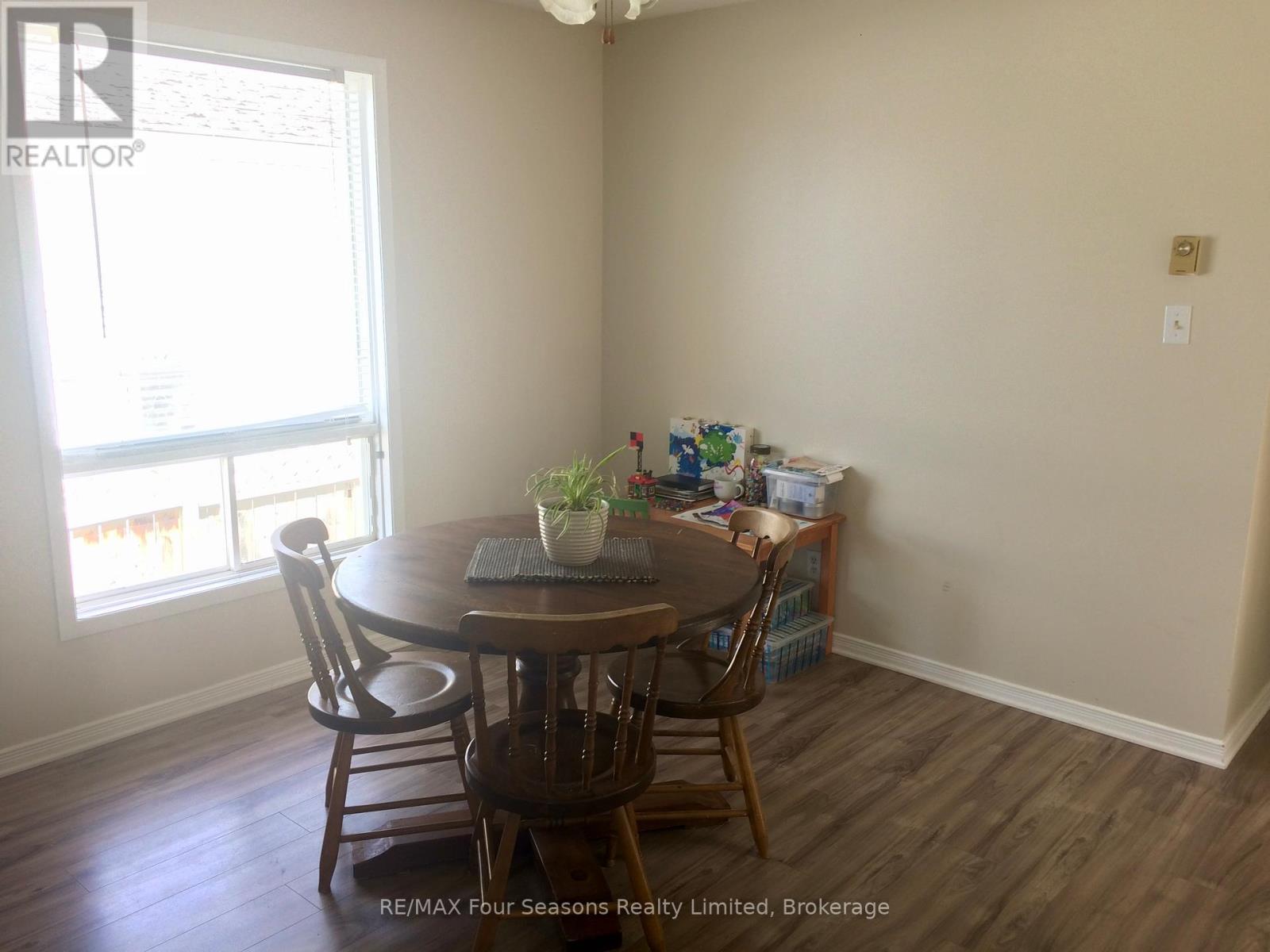 A dining room with a table and chairs.