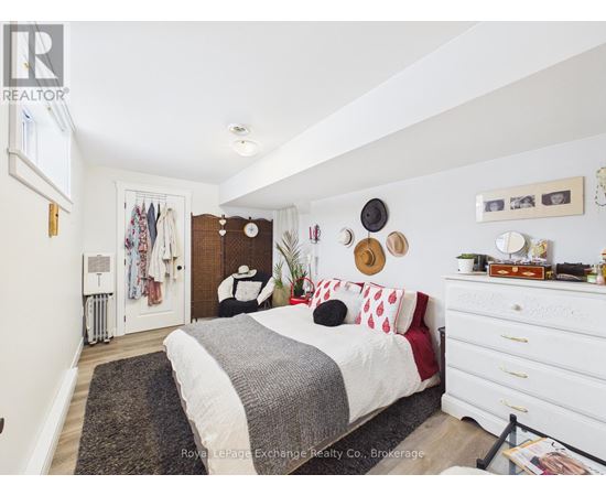 A bedroom with a bed, dresser, and mirror.
