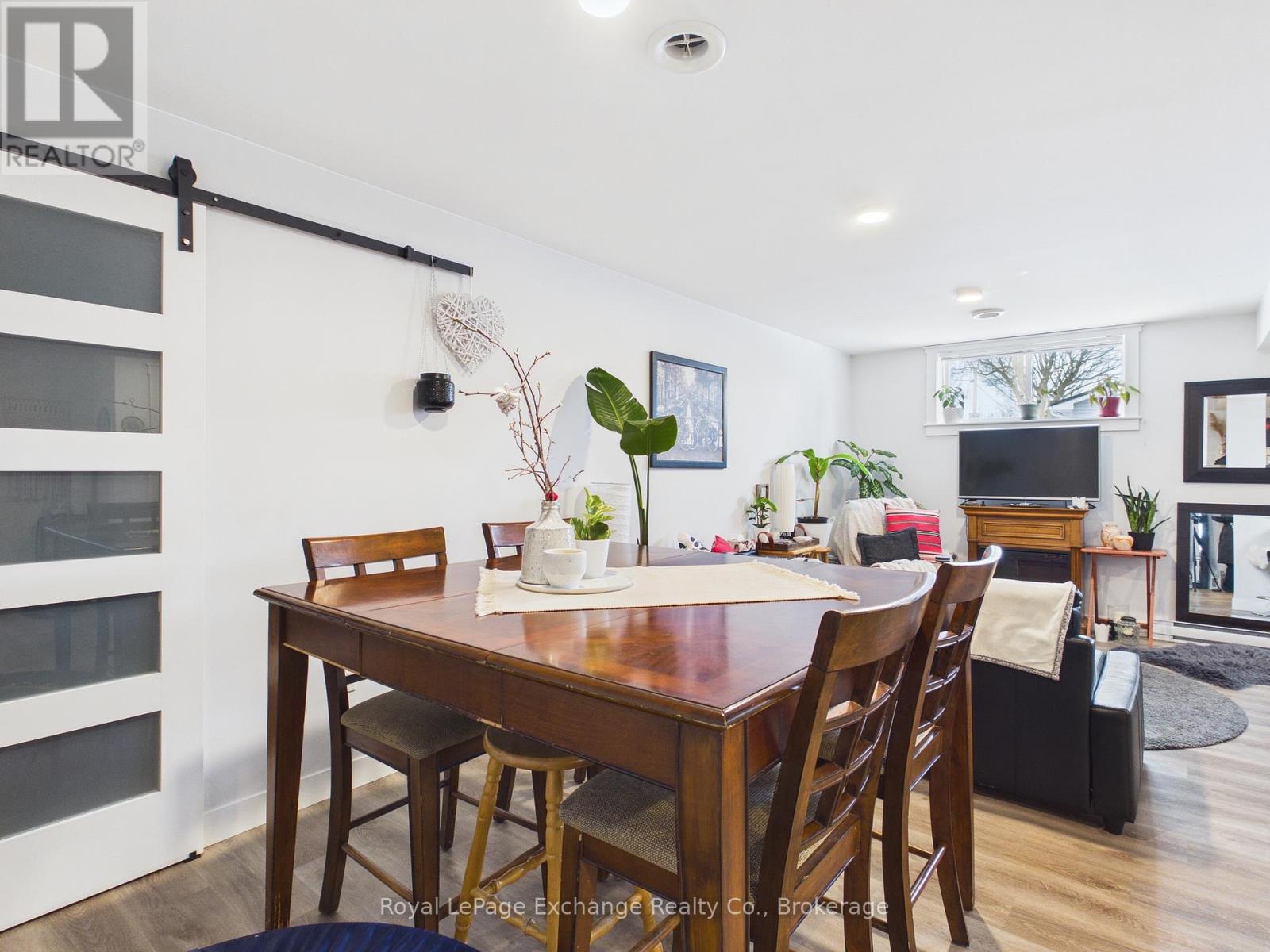 A dining room with a wooden table and chairs.