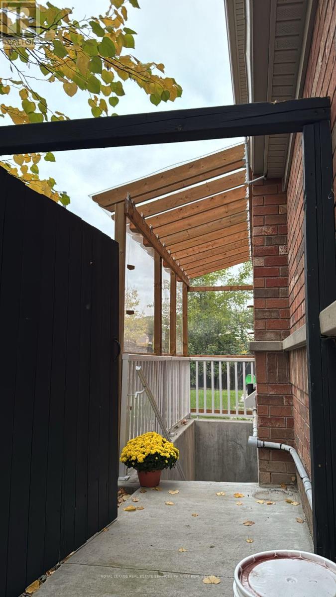 A black gate leads to a wooden deck.