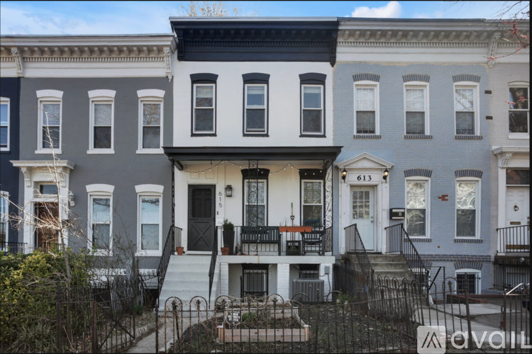A row of houses with the middle one being the most prominent.