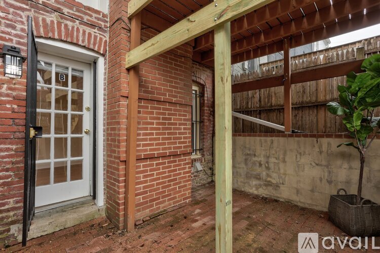 A patio area with a door and a plant.