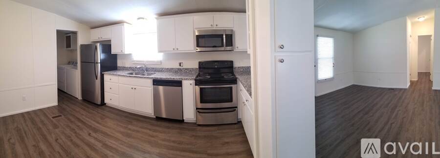 A kitchen with white cabinets and stainless steel appliances.