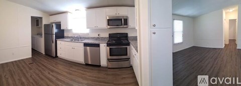 A kitchen with white cabinets and stainless steel appliances.