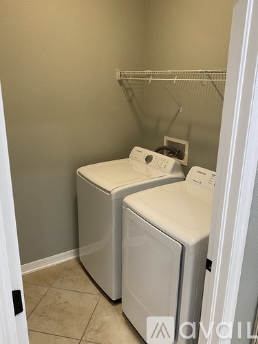 Two front load washing machines in a laundry room.