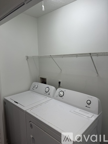 A white washing machine and dryer in a small laundry room.