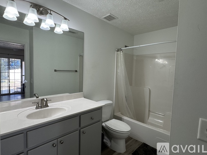 A bathroom with a sink, toilet, and bathtub.