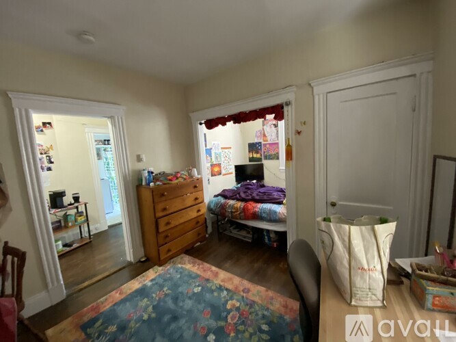 A room with a bed, dresser, and window.